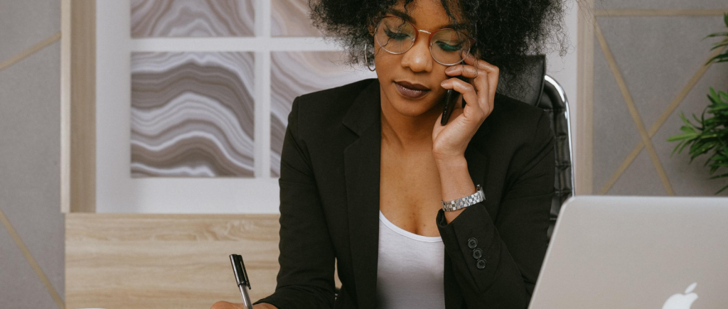 Business woman talking on phone with spreadsheets