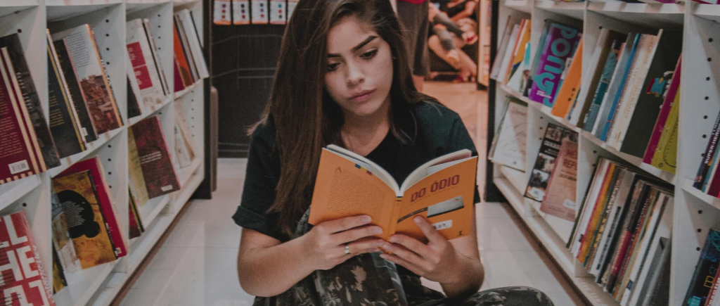 girl reading a book in a library